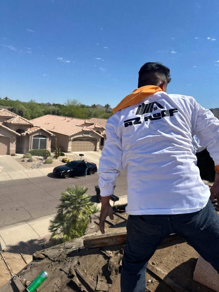 Expert roofers assessing a roof for emergency repairs in Scottsdale.