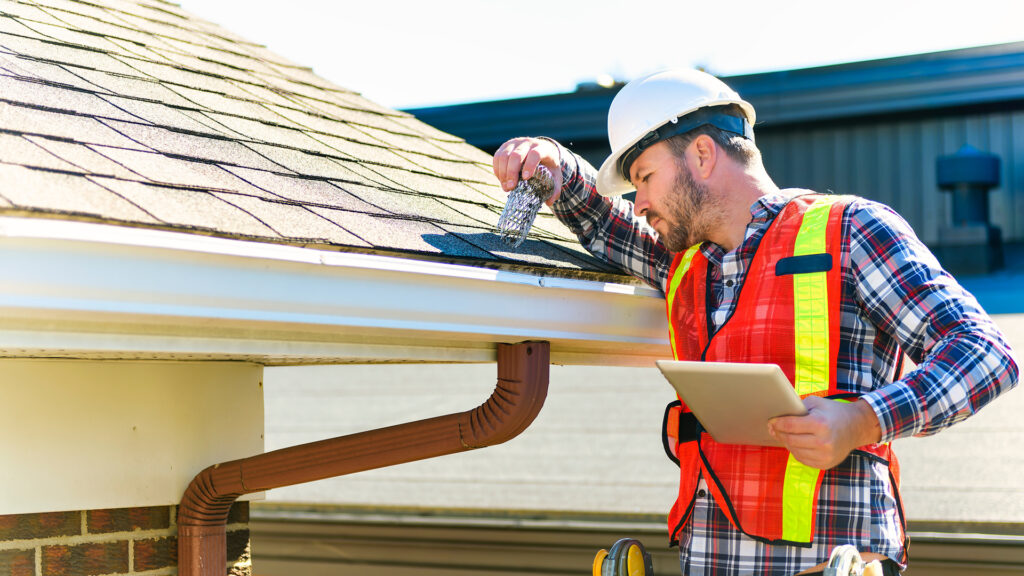 A team of commercial roofing contractors assessing a roof for repairs, illustrating the search for reliable commercial roof repair near me.