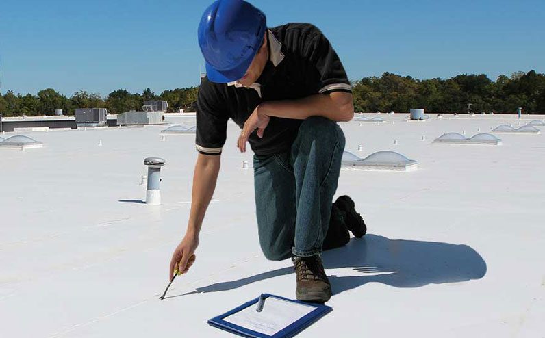 A person inspecting a roof for damage to get an accurate roof repair estimate.